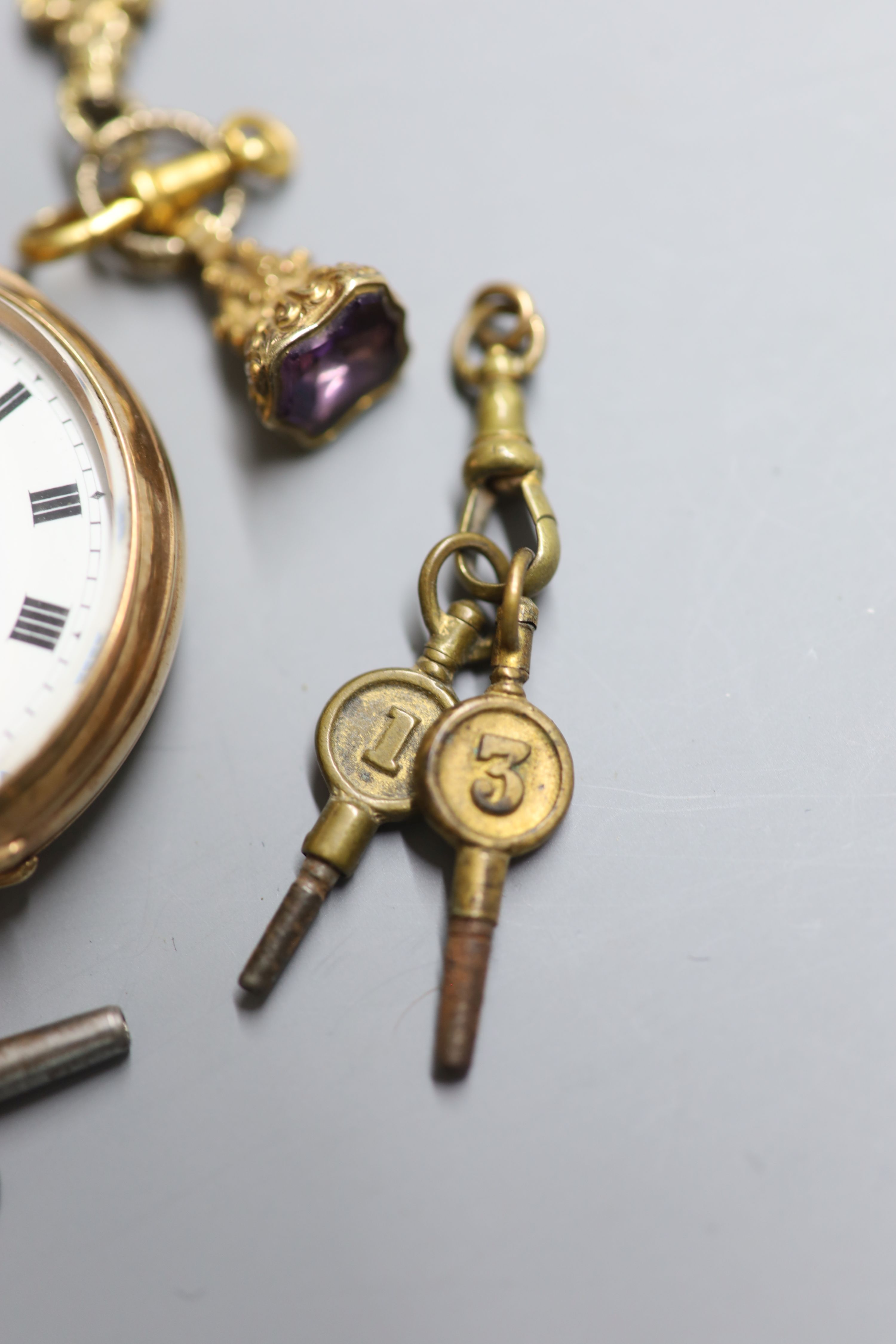 A George V 9ct gold open faced keyless lever pocket watch, retailed by Hinds Ltd, London, six watch keys and a gem set fob seal,